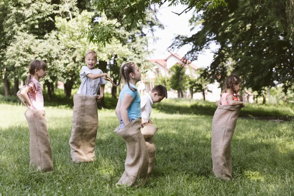 children-running-burlap-bags